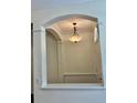 Elegant foyer features an arched entryway and a stylish chandelier at 12863 Holdenbury Ln, Windermere, FL 34786