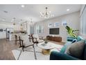 Bright and airy living room featuring hardwood floors and modern furnishings at 13852 Maskawa Ave, Orlando, FL 32827