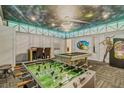 Spacious game room with foosball, pool table, and unique ceiling art at 1400 Moon Valley Dr, Davenport, FL 33896