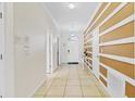 Bright hallway with tile flooring and decorative wall trim, leading to the main entrance at 1400 Moon Valley Dr, Davenport, FL 33896
