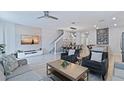 Open-concept living area with modern furnishings and ample space for relaxation and entertaining at 1563 Sandbagger Dr, Davenport, FL 33896