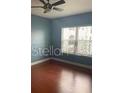 Cozy bedroom with wood flooring, and a bright window offering ample natural light at 204 E South St # 5057, Orlando, FL 32801