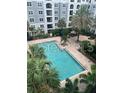 Inviting swimming pool surrounded by lush tropical landscaping, offering a serene outdoor retreat at 204 E South St # 5057, Orlando, FL 32801