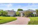 Elegant home featuring brick driveway, well-maintained lawn and manicured shrubbery at 2527 Mohawk Trl, Maitland, FL 32751