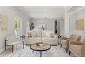 Cozy living room featuring a comfortable sofa, a modern coffee table and a stylish rug at 2527 Mohawk Trl, Maitland, FL 32751