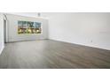 Spacious living room with wood floors, natural light, and neutral walls at 3038 Clubview Dr # Ge, Orlando, FL 32822