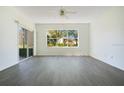 Bright and airy living room featuring wood floors and a large window view at 3038 Clubview Dr # Ge, Orlando, FL 32822