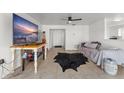 Spacious living room with tile floors, a modern ceiling fan, and a large TV at 3121 Heartwood Ave, Winter Park, FL 32792