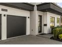 Attached two-car garage with a dark door, modern lighting, and a well-kept yard at 3322 Helen Ave, Orlando, FL 32804