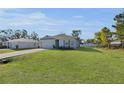 Single-story home with a large, well-maintained lawn and attached garage at 355 Gardenia Ct, Kissimmee, FL 34759