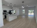 Bright open-concept kitchen with stainless steel appliances and a spacious living area at 4031 Sw 130Th Loop, Ocala, FL 34473