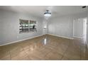Spacious living room with tile floors and lots of natural light at 411 Thomas Ave, Frostproof, FL 33843
