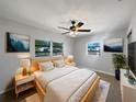 Comfortable bedroom with two windows, ceiling fan, and modern décor at 411 Thomas Ave, Frostproof, FL 33843