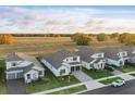 Aerial view of several two-story homes, showcasing their layout and green surroundings under a blue sky at 4778 Cragmere Loop, Clermont, FL 34711