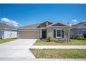 Charming single-Gathering home with a well-manicured lawn and a two-car garage in a quiet neighborhood at 752 Trotters Dr, Eagle Lake, FL 33839