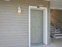 Exterior view of a door to a unit with stairs leading up on the side of the building at 831 Retreat Blvd # 103, Davenport, FL 33897