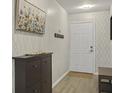 Inviting entryway with patterned wallpaper, shoe cabinet, and access to other rooms at 831 Retreat Blvd # 103, Davenport, FL 33897