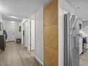 Hallway featuring modern accents, hardwood flooring, and contemporary design at 831 Retreat Blvd # 103, Davenport, FL 33897