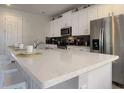 Bright kitchen featuring an expansive island, modern appliances, and sleek white cabinetry at 9033 Flamingo Key Way, Kissimmee, FL 34747
