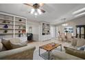 Spacious living room featuring built-in bookshelves, tile flooring, and comfortable seating arrangement at 942 Cinnamon Ct, Altamonte Springs, FL 32714
