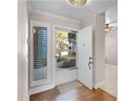 Light-filled entryway featuring hardwood floors, tiled flooring, and a view of the outdoors at 139 Durham Pl, Longwood, FL 32779