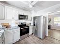 Modern kitchen featuring stainless steel appliances, granite countertops, and bright white cabinets at 1503 Holly Rd, Lakeland, FL 33801