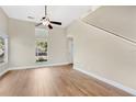 Bright living room with high ceilings, light-toned walls, wood-look floors, and modern ceiling fan at 155 Aunt Polly Ct, Orlando, FL 32828