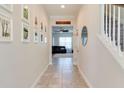 Inviting hallway with tiled floors, leading to a spacious living area and staircase at 15837 Sweet Lemon Way, Winter Garden, FL 34787