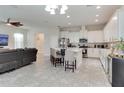 Modern, open-concept kitchen with white cabinetry, stainless appliances, and a center island at 15837 Sweet Lemon Way, Winter Garden, FL 34787