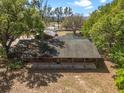 Aerial view of the log cabin home and the detached outbuilding at 16510 Quarter Horse Ct, Montverde, FL 34756