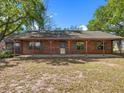 Traditional log cabin with a long, covered porch offering ample outdoor seating space at 16510 Quarter Horse Ct, Montverde, FL 34756