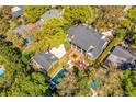 Aerial view of a luxury home showcasing its manicured backyard and sparkling swimming pool at 1911 Stonehurst Rd, Winter Park, FL 32789