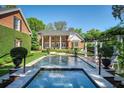 Expansive backyard showcasing the pool, patio, and meticulously maintained landscaping of the estate at 1911 Stonehurst Rd, Winter Park, FL 32789