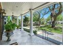 Inviting front porch with classic white columns and a welcoming view of the landscaped front yard at 1911 Stonehurst Rd, Winter Park, FL 32789