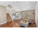 Cozy living room with wood floors, a comfortable couch, and an adjoining kitchen area at 2046 Ambergris Dr, Orlando, FL 32822