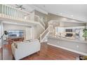 Inviting living room with vaulted ceilings, staircase, and an open flow to the modern kitchen at 2046 Ambergris Dr, Orlando, FL 32822