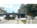 Charming single-story home with a well-maintained front yard and a black roof at 214 Lucile Way, Orlando, FL 32835