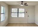 Sunlit living room featuring a window, tiled floor, and a ceiling fan at 214 Lucile Way, Orlando, FL 32835