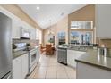 Bright kitchen with white cabinets, stainless steel appliances, and an adjacent dining area at 2248 Wyndham Palms Way, Kissimmee, FL 34747