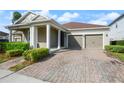 Charming home featuring a well-manicured lawn, covered entryway, and a two-car garage at 3242 Irish Peach Dr, Winter Garden, FL 34787