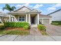 Charming home featuring a well-manicured lawn, covered entryway, and a two-car garage at 3242 Irish Peach Dr, Winter Garden, FL 34787