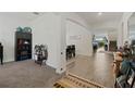 Hallway with open floor plan, showcasing access to carpeted living area and an adjacent dining room at 4796 Riverwalk Dr, St Cloud, FL 34771