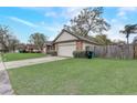 Charming single-story brick home featuring an attached garage and a spacious, well-kept lawn at 5444 Lighthouse Rd, Orlando, FL 32808