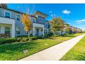 Attractive townhomes with well-kept lawns along a sidewalk offering curb appeal at 5814 Bimini Twist Loop, Orlando, FL 32819