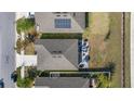 An aerial perspective of a house with a patio set, including a table, chairs, and umbrella in the backyard at 5841 Bullock Pl, St Cloud, FL 34771