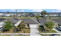 An aerial view of a well-maintained home with green lawns and a neatly paved driveway in a neighborhood at 5841 Bullock Pl, St Cloud, FL 34771