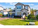 Charming two-story home featuring a well-manicured lawn, brick driveway, and attached two-car garage at 753 Daybreak Pl, Longwood, FL 32750