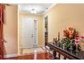 Warm and welcoming foyer with hardwood flooring, elegant décor, and a view into the adjacent living spaces at 755 Country Charm Cir, Oviedo, FL 32765