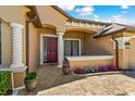 Inviting front porch with brick pavers, decorative columns, and colorful flower accents for added curb appeal at 755 Country Charm Cir, Oviedo, FL 32765