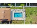 An aerial view of a rectangular community pool surrounded by chairs and lounge furniture at 1001 Plantation Dr # D5, Kissimmee, FL 34741